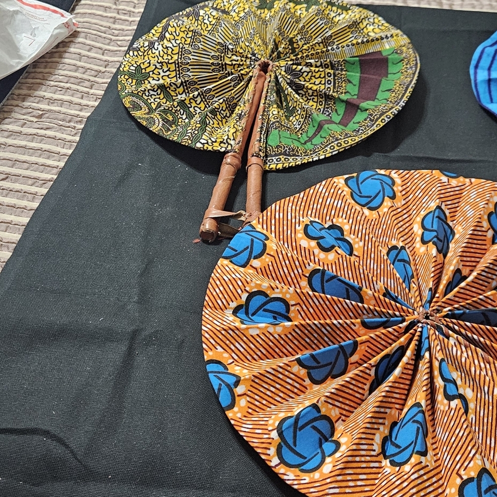 Traditional Ghanaian cotton kente print and tie and dye print fans, with leather